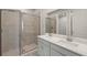Bright bathroom featuring a double sink vanity with modern fixtures and a glass-enclosed shower at 20423 Symphony Pl, Venice, FL 34293