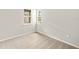 Bright bedroom with neutral carpeting, white walls, baseboards and two windows with neighborhood views at 20423 Symphony Pl, Venice, FL 34293
