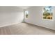 Inviting bedroom with carpet floors, two windows and bright walls at 20423 Symphony Pl, Venice, FL 34293