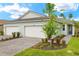Charming single-story home with a three-car garage and a well-manicured lawn at 20423 Symphony Pl, Venice, FL 34293