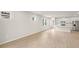 Spacious living area with bright tile flooring and modern kitchen view at 20423 Symphony Pl, Venice, FL 34293