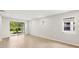 Sunlit living room featuring neutral walls, tile floors and backyard views at 20423 Symphony Pl, Venice, FL 34293