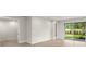 Bright living room with tiled floors and sliding glass door to backyard patio at 20423 Symphony Pl, Venice, FL 34293