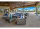 Covered patio with comfortable seating overlooking the pool and palms at 20423 Symphony Pl, Venice, FL 34293