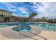 Community pool with hot tub and tropical landscaping on a sunny day at 20423 Symphony Pl, Venice, FL 34293