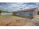 The home features a spacious backyard with a well-maintained lawn at 2105 Sugarbush Dr, Holiday, FL 34690