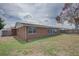 View of the back exterior of the home with fenced yard at 2105 Sugarbush Dr, Holiday, FL 34690