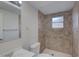 Tiled shower and toilet in updated bathroom with ample lighting and vanity at 2105 Sugarbush Dr, Holiday, FL 34690
