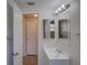 Bathroom featuring vanity sink, mirror, and view of the tiled shower at 2105 Sugarbush Dr, Holiday, FL 34690