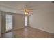 Bedroom featuring tile floors, fan, and windows with mini blinds at 2105 Sugarbush Dr, Holiday, FL 34690