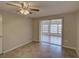 Bright bedroom with tile floors, ceiling fan, and a sliding glass door to the patio at 2105 Sugarbush Dr, Holiday, FL 34690