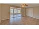 Bright bedroom with tile flooring, ceiling fan, and sliding doors to a sunroom at 2105 Sugarbush Dr, Holiday, FL 34690