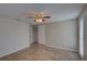 Neutral bedroom featuring tile floors, closet space and a ceiling fan at 2105 Sugarbush Dr, Holiday, FL 34690