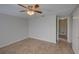 Neutral bedroom featuring tile floors, ceiling fan, and two closets at 2105 Sugarbush Dr, Holiday, FL 34690