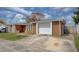Exterior of the home showing the garage and driveway at 2105 Sugarbush Dr, Holiday, FL 34690