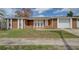 Inviting single-story home with a two-car garage and well-maintained front yard at 2105 Sugarbush Dr, Holiday, FL 34690