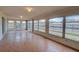 Sunroom featuring tile floor and windows overlooking the backyard at 2105 Sugarbush Dr, Holiday, FL 34690