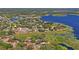 Beautiful aerial view of a lakeside community with lush greenery and stunning water views at 223 Eastpoint Ct, Spring Hill, FL 34606