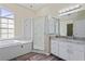 Bright bathroom with granite counters, a shower and large tub at 223 Eastpoint Ct, Spring Hill, FL 34606