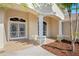 Welcoming front porch with decorative columns and tile flooring leading to a charming double door entry at 223 Eastpoint Ct, Spring Hill, FL 34606