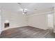 Open living room with modern floors, a fan, and a charming fireplace at 223 Eastpoint Ct, Spring Hill, FL 34606