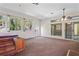 Bright sun room with carpet, multiple windows, and sliding glass doors to the backyard at 223 Eastpoint Ct, Spring Hill, FL 34606
