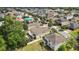 Aerial view of backyard and screened-in porch in a community with mature trees at 2387 Bartolo Dr, Land O Lakes, FL 34639