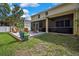Lush backyard with a pergola swing, patio area, and ample green space at 2387 Bartolo Dr, Land O Lakes, FL 34639
