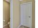 Powder room featuring tiled flooring, a toilet, and a white door at 2387 Bartolo Dr, Land O Lakes, FL 34639