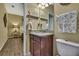 Bathroom showcasing a granite sink and view of the bedroom at 2387 Bartolo Dr, Land O Lakes, FL 34639