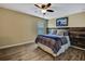 A bedroom showcasing wood flooring, neutral paint, a window, and a wooden headboard at 2387 Bartolo Dr, Land O Lakes, FL 34639