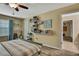 Cozy bedroom featuring a ceiling fan, creative shelving, and wood-look flooring at 2387 Bartolo Dr, Land O Lakes, FL 34639