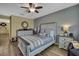 Charming bedroom with wood-look flooring, decorative mirror, and cozy furnishings at 2387 Bartolo Dr, Land O Lakes, FL 34639