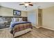 Comfortable bedroom features wood accent wall and decorative ceiling fan at 2387 Bartolo Dr, Land O Lakes, FL 34639