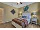 Well-lit bedroom with a cozy bed and decorative wall art at 2387 Bartolo Dr, Land O Lakes, FL 34639