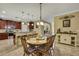 Cozy dining area with a round table and wooden chairs, conveniently located near the kitchen and living spaces at 2387 Bartolo Dr, Land O Lakes, FL 34639