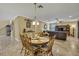 Open-concept dining area with a round table next to the living room, creating a seamless and inviting space at 2387 Bartolo Dr, Land O Lakes, FL 34639