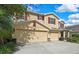 Charming two-story home featuring a three-car garage and eye-catching red shutters at 2387 Bartolo Dr, Land O Lakes, FL 34639