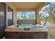 Relaxing hot tub on screened lanai, with a view of the landscaped backyard at 2387 Bartolo Dr, Land O Lakes, FL 34639
