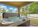A luxurious outdoor hot tub on a screened patio, perfect for relaxation with a view of the lush backyard at 2387 Bartolo Dr, Land O Lakes, FL 34639