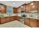 Well-appointed kitchen with stylish cabinetry, granite countertops, and stainless steel appliances for a modern aesthetic at 2387 Bartolo Dr, Land O Lakes, FL 34639