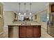 Open kitchen design with granite island and stainless steel dishwasher at 2387 Bartolo Dr, Land O Lakes, FL 34639