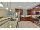 Well-lit kitchen features granite countertops and stainless steel appliances at 2387 Bartolo Dr, Land O Lakes, FL 34639