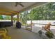 Inviting screened lanai with hot tub, grill, and view of the serene backyard at 2387 Bartolo Dr, Land O Lakes, FL 34639