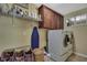 Efficient laundry room with storage cabinets and modern washer/dryer at 2387 Bartolo Dr, Land O Lakes, FL 34639