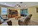 Comfortable living room with a large entertainment center and sliding glass doors leading to outdoor space at 2387 Bartolo Dr, Land O Lakes, FL 34639