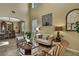 Cozy living room featuring high ceilings, tile flooring, and stylish furnishings, perfect for entertaining or relaxing at 2387 Bartolo Dr, Land O Lakes, FL 34639