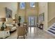 Bright living room featuring high ceilings, large windows and stylish decor at 2387 Bartolo Dr, Land O Lakes, FL 34639