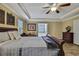 A bright main bedroom featuring a wooden bed frame, neutral paint, and wood flooring at 2387 Bartolo Dr, Land O Lakes, FL 34639