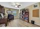 Home office featuring built-in bookshelves and a ceiling fan at 2387 Bartolo Dr, Land O Lakes, FL 34639